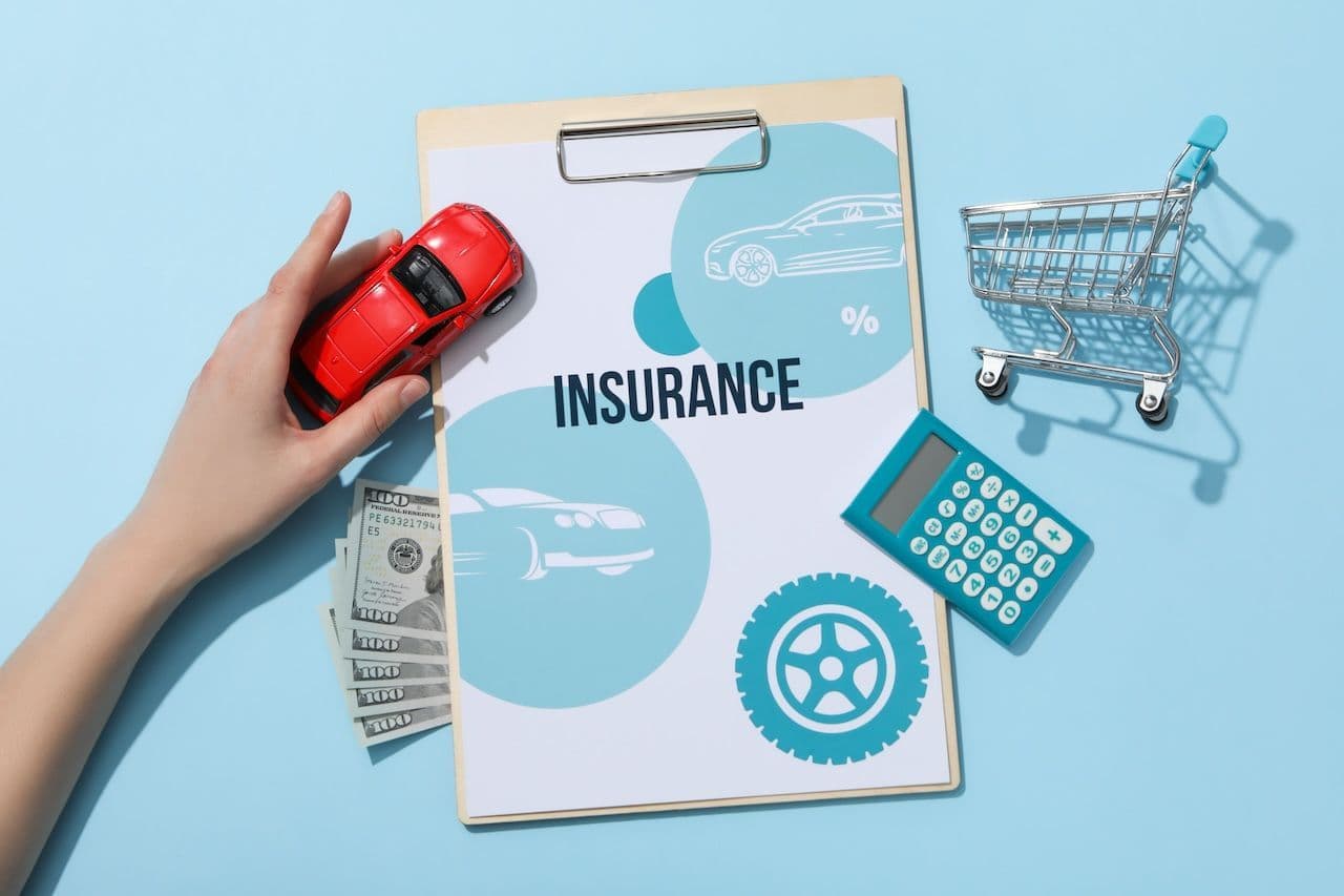 A toy car, shopping cart, and calculator on a clipboard that reads, "insurance," illustrating Florida insurance requirements.