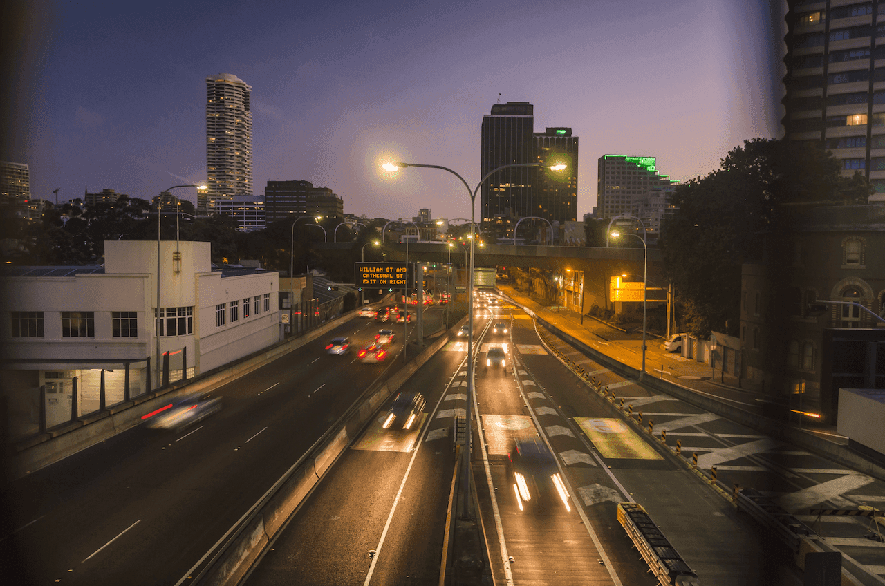 An overhead view of moving cars on a Florida roadway at night.