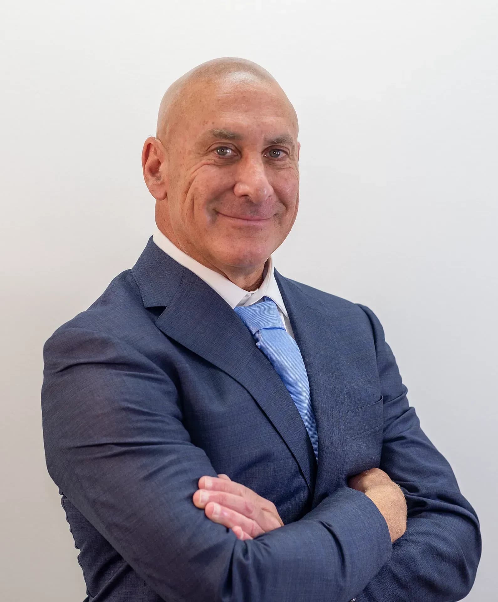 Florida personal injury lawyer Scott J. Senft smiling with arms crossed.